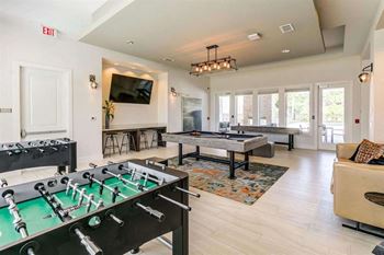 Game room with billiards, foosball & shuffle board